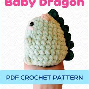 May include: A crochet pattern for a green baby dragon amigurumi. The pattern is available as a PDF download. The image shows a finished crocheted baby dragon.
