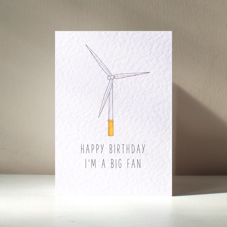 May include: A white card with a simple line drawing of a wind turbine. The text "Happy Birthday I'm a big fan" is printed below the image.
