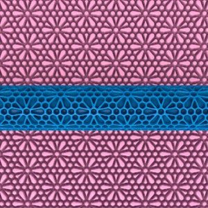 May include: A blue plastic rolling pin with a decorative pattern of circles and stars. The rolling pin is on top of a pink patterned surface.