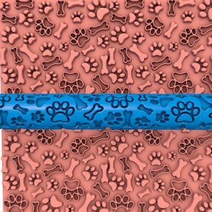 May include: Blue rolling pin with paw print and bone designs. The rolling pin is on top of a pink surface with the same paw print and bone designs.