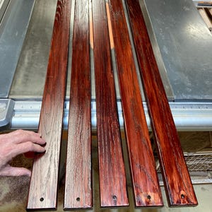 Red Oak slats, 5 pieces at 3/4” x 2-1/2” x 48”, 5/16” Dia holes 3/4” from each end, centered, rounded edges, with stain and outdoor varnish.