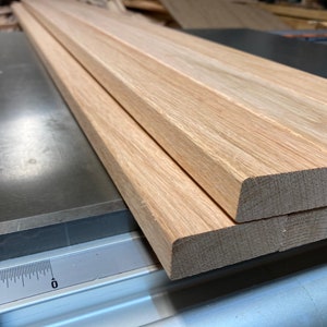 Red Oak slats, 12 pieces total, nine at 3/4” x 2-1/4” x 48”, three at 3/4” x 1-1/2” x 48”, surface planed, rounded edges.