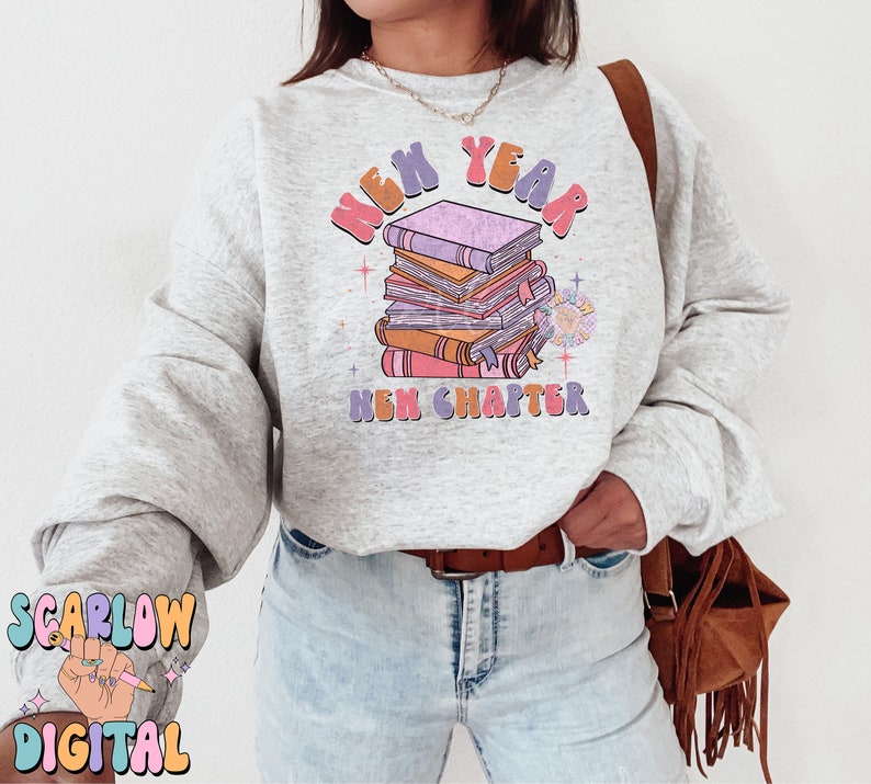May include: A grey sweatshirt with a stack of books and the text "New Year New Chapter" in a colourful retro font.