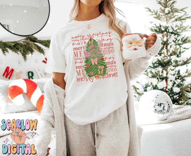 May include: White t-shirt with a green Christmas tree design and the text "merry christmas" repeated in various sizes and colors.
