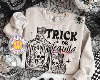 May include: Beige sweatshirt with a black and white graphic of a tequila bottle and shot glass with a skull design. The text "Trick or Tequila" is printed on the front. Black spiders and a disco ball are also in the image.