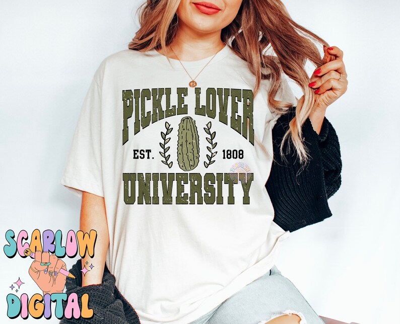 May include: White t-shirt with a green graphic that says "Pickle Lover University" with a pickle image and the text "Est. 1808".