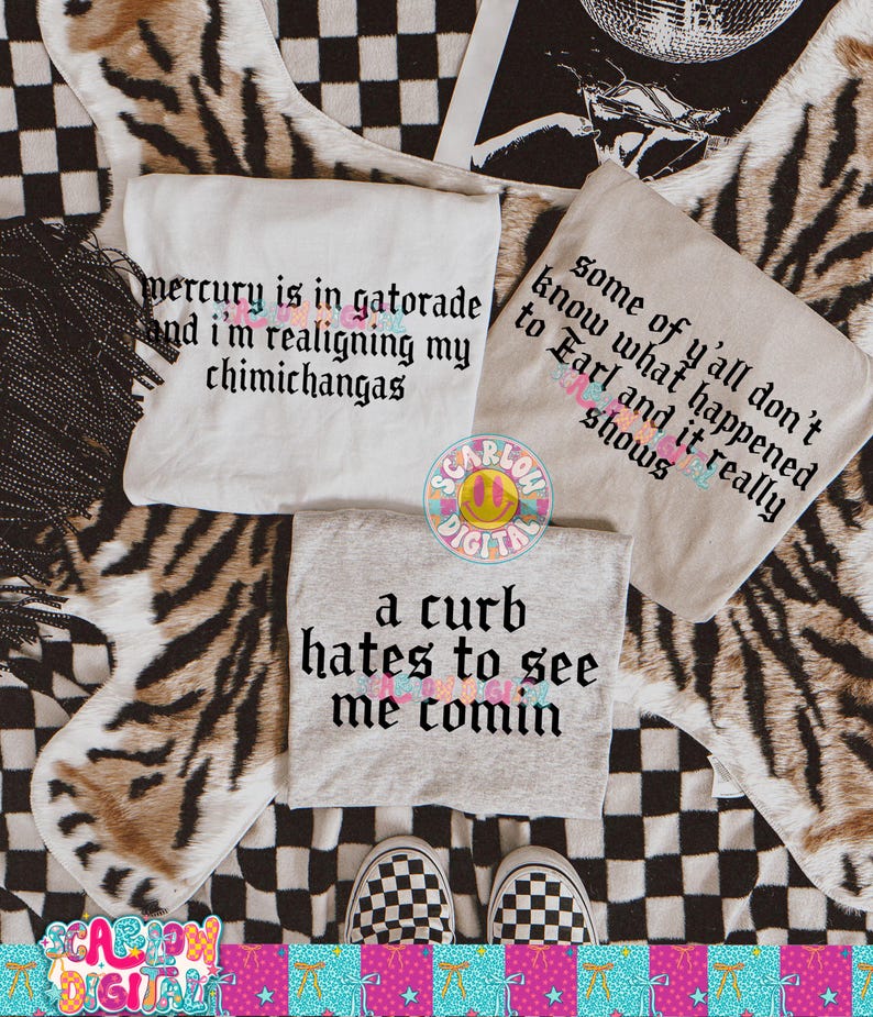 May include: Three t-shirts with text are displayed on a patterned surface. One shirt is white with the text "mercury is in gatorade and I'm realigning my chimichangas." Another is tan with the text "some of y'all don't know what happened to Earl and it really shows." The third is gray with the text "a curb hates to see me comin."