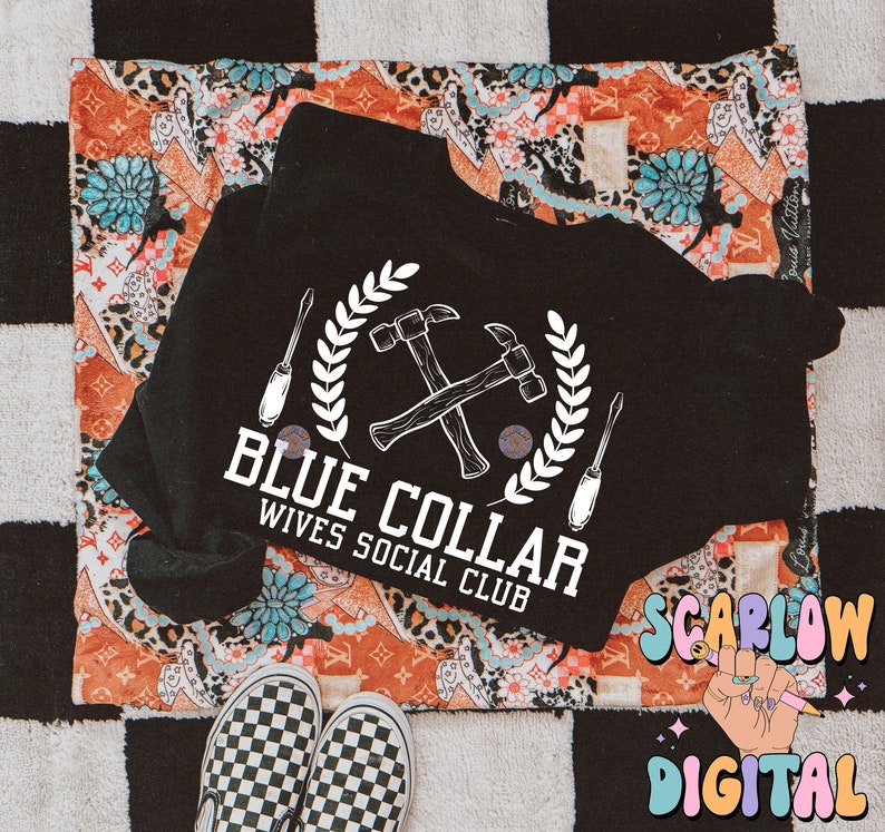 May include: Black t-shirt with a white graphic of crossed hammers and screwdrivers with a wreath around them. The text "Blue Collar Wives Social Club" is below the graphic.