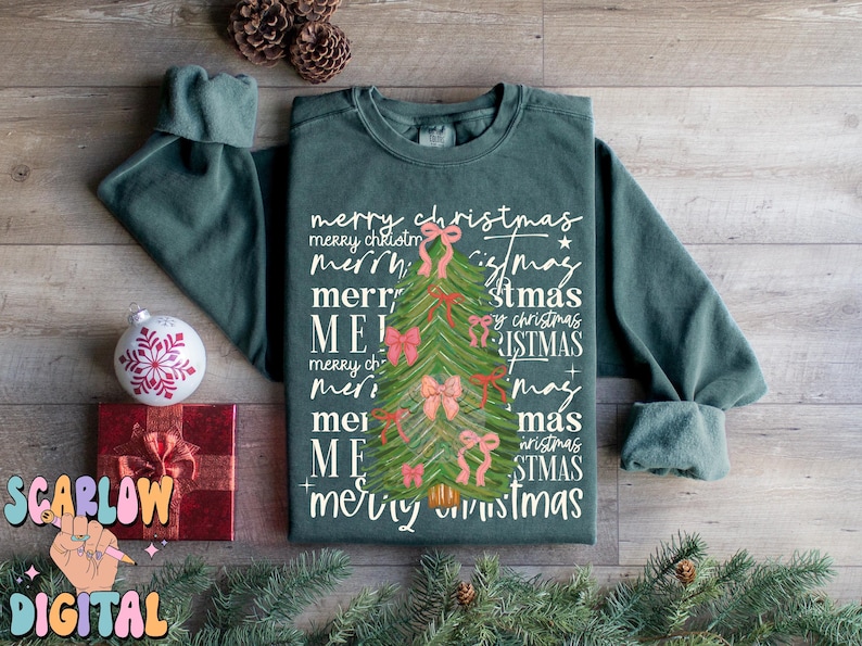 May include: A green sweatshirt with a Christmas tree design and the text "merry christmas" repeated multiple times in different variations.