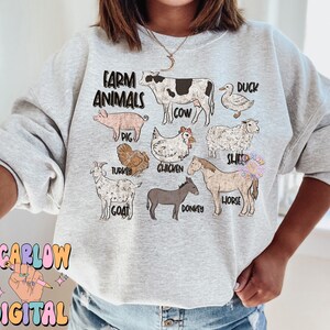May include: A gray sweatshirt with the text "Farm Animals" printed on the front. The design features illustrations of a cow, pig, duck, sheep, turkey, chicken, goat, donkey, and horse.