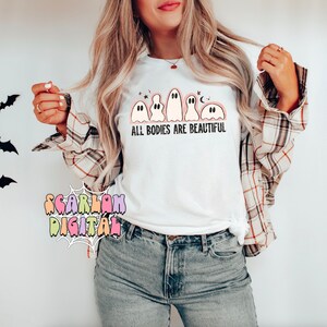 May include: White t-shirt with a line of cartoon ghosts and the text "ALL BODIES ARE BEAUTIFUL".
