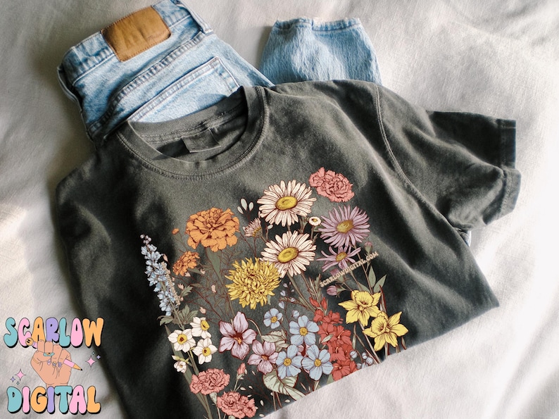May include: A dark gray t-shirt with a floral print featuring a variety of colorful flowers, including pink, yellow, orange, and blue.