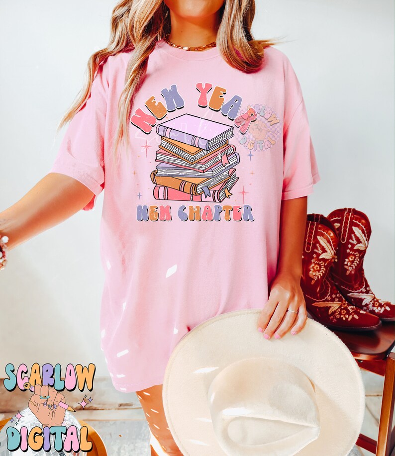 May include: Pink t-shirt featuring a graphic design of a stack of books with the text "New Year New Chapter".