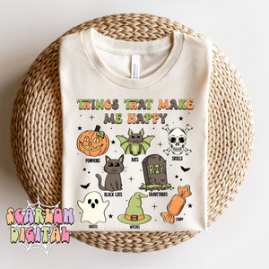 May include: A white t-shirt with the text "Things that make me happy" and a list of Halloween-themed items, including pumpkins, bats, skulls, black cats, graveyards, ghosts, witches, and candy.