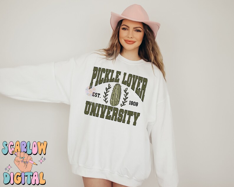 May include: White sweatshirt with a green graphic that says "Pickle Lover University" with a pickle image and the text "Est. 1808".