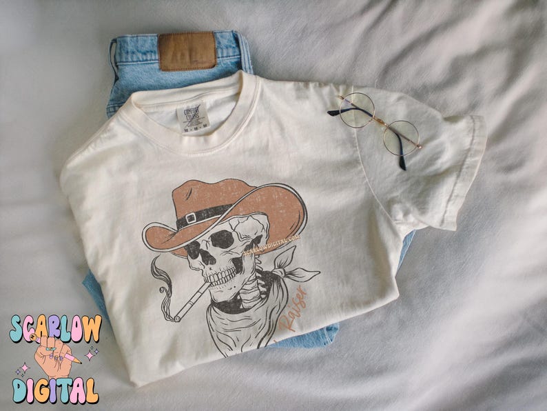 May include: A white t-shirt with a graphic of a skeleton wearing a cowboy hat and smoking a pipe. The text "Rouser" is printed on the shirt.
