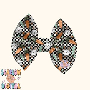 May include: A black and white checkered bow with a green, orange, and white bunny and carrot pattern. The bow is made of fabric and has a shiny finish.