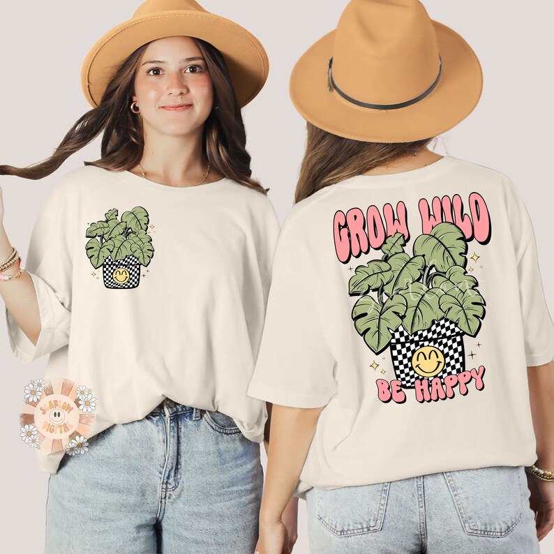May include: White t-shirt with a green plant in a black and white chequered pot with a smiley face on the front. The back of the shirt has a pink "Grow Wild" text with a green plant in a black and white chequered pot with a smiley face and the text "Be Happy" underneath.