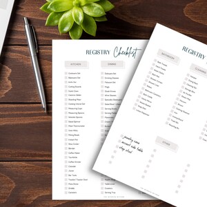 May include: A checklist for a wedding registry with categories for kitchen, dining, bathroom, cleaning, home decor, and other. The checklist is printed on white paper with a light grey background.