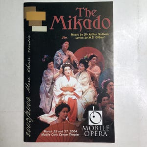 May include: A 2003/2004 Mobile Opera programme for The Mikado featuring a cast in traditional Japanese attire. The cover displays the title, credits to Sir Arthur Sullivan and W.S. Gilbert, and event dates of March 25 and 27, 2004, at the Mobile Civic Center Theater.