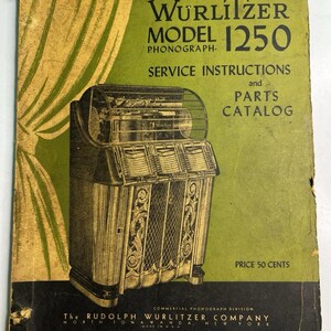 May include: A vintage Wurlitzer Model 1250 phonograph service instructions and parts catalog manual. The green and black cover features a black and white illustration of a jukebox, with text reading Wurlitzer Model 1250, Price 50 Cents, and Part No 308-S.