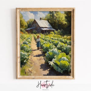 May include: A framed print depicting a farm scene. A person in a straw hat and blue skirt walks along a path between rows of large green cabbages. A wooden farmhouse is in the background, surrounded by trees. The print is signed "Heartside Prints".