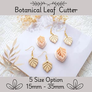 Puede incluir: Imagen de pendientes y cortadores con forma de hoja. Los pendientes son de color beige con ganchos dorados. Los cortadores son rosas y beige. El texto dice "Botanical Leaf Cutter" y "5 Size Option 15mm - 35mm".