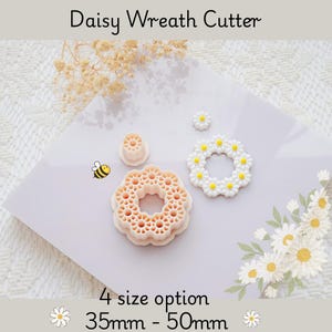 May include: A collection of daisy wreath cutters in various sizes. The image shows the cutters, a finished wreath, and a small bee graphic. Text on the image reads "Daisy Wreath Cutter" and "4 size option 35mm - 50mm".