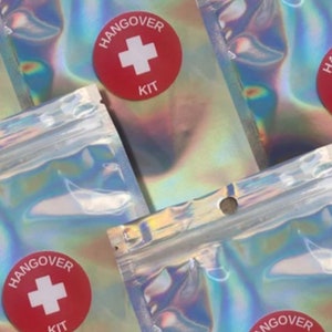 Holographic zip lock bag with red and white hangover kit sticker on the front.