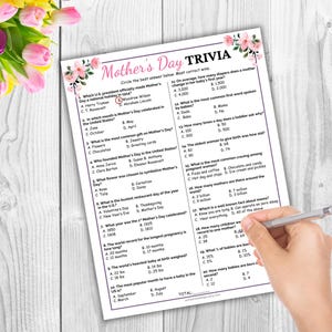 May include: A printable Mother's Day trivia game with pink floral accents. The game includes questions about Mother's Day history, traditions, and interesting facts.  The questions are multiple choice with four options each.