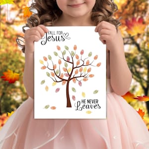 May include: A white printable sign with a brown tree with colorful leaves. The text "Fall for Jesus" is at the top of the sign. The text "He Never Leaves" is at the bottom of the sign.