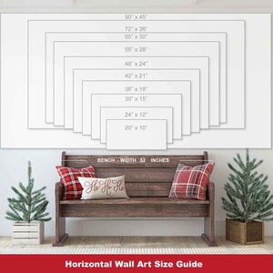 May include: A wall art size guide displays various rectangular canvas sizes, from 20" x 10" to 90" x 45". A wooden bench, 52 inches wide, is below the guide, with plaid pillows and a decorative pillow that says "Ho Ho Ho". Two small Christmas trees flank the bench.