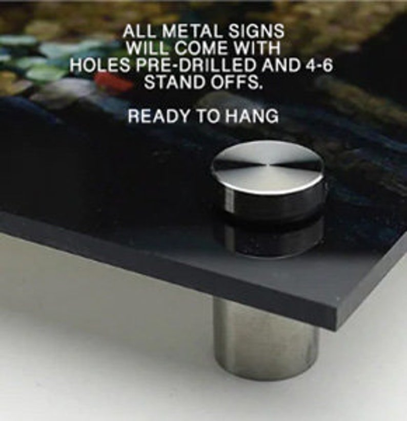 May include: A black metal sign with a silver stand-off. The sign has the text "ALL METAL SIGNS WILL COME WITH HOLES PRE-DRILLED AND 4-6 STAND OFFS. READY TO HANG."