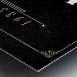 May include: A black metal sign with gold trim and the text "1961" in white.