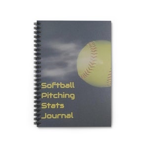 May include: A gray spiral bound journal with the text "Softball Pitching Stats Journal" and a yellow softball flying through the air.