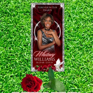 May include: A digital download for a custom grave blanket featuring a photo of Whitney Houston with the text "Forever in Our Hearts" and "Whitney Williams 06-25-68 - 12-15-24". The image is set against a red background with a white dove and roses.