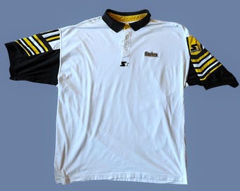 May include: White polo shirt with black and yellow accents. The shirt features black sleeves with yellow and white stripes, a black collar with yellow trim, and the Steelers logo. The Starter logo is also visible.