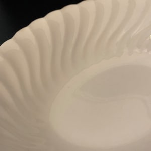 May include: White ceramic dinner plate with a wavy, rippled design.