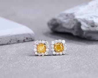 Genuine natural fancy yellow diamond cushion cut gold earrings. SI-VS quality 0.5-1 carat total weight. Canary Yellow diamond halo earrings.