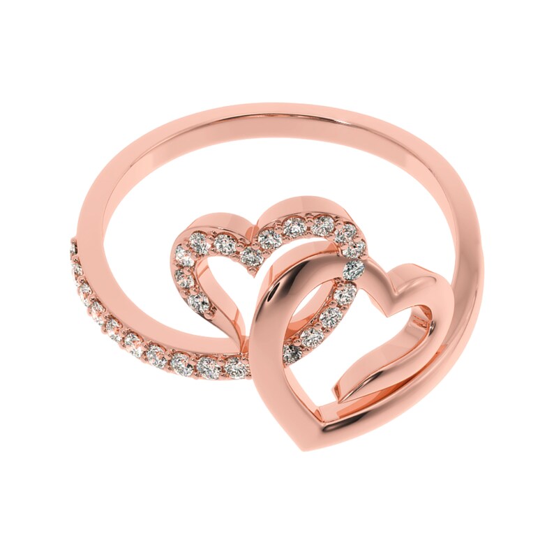 May include: A rose gold ring with two interlocking hearts, each heart is outlined with small clear stones.