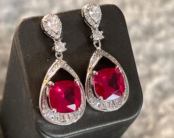 Red ruby gemstone earrings. Pear cut ruby diamond dangle earrings. Diamond halo ruby earrings in sterling silver. Teardrop dangling earrings