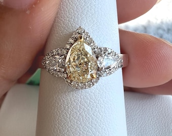 1.10 tcw natural fancy yellow diamond engagement ring. 0.75ct Pear cut Diamond wedding ring. Teardrop side stones halo ring in white gold