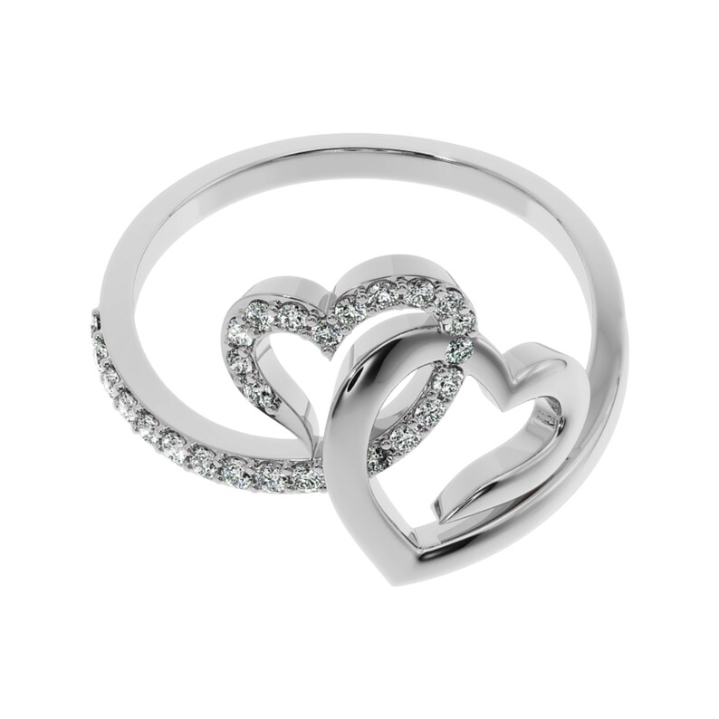 May include: A silver ring with two interlocking heart designs, each heart is accented with small clear stones.