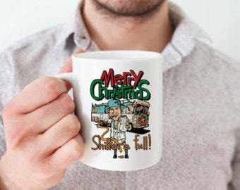 May include: White ceramic mug with a cartoon illustration of a man in a Christmas sweater and a Santa hat, standing next to a decorated RV. The text "Merry Christmas Shitter's Full!" is printed on the mug.