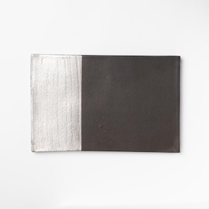 May include: A rectangular ceramic serving tray with a white and black glaze. The tray is divided in half, with the left side being white and the right side being black.