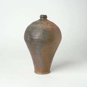 May include: A brown ceramic vase with a rounded body and a narrow neck. The vase has a mottled glaze with shades of brown, gray, and black.