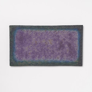 May include: A rectangular ceramic tray featuring a textured surface with a vibrant purple center. The edges are defined by a gradient transition from a deep blue to a dark, mottled charcoal black border, creating a distinct frame around the purple.