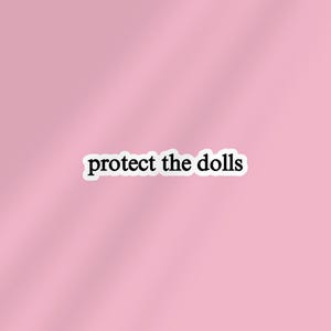 May include: A sticker with the text "protect the dolls" in a black font with a white border. The sticker is set against a soft pink background.