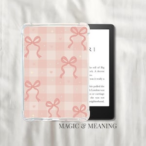 May include: A clear e-reader case with a pink gingham design and pink bow motifs. The e-reader shows text on a white screen. The words "MAGIC & MEANING" are at the bottom of the image.