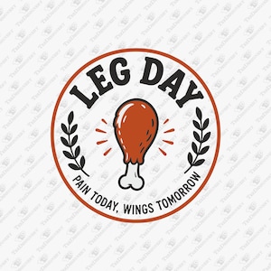 May include: A circular graphic design featuring a brown chicken leg in the center with black text reading LEG DAY at the top and PAIN TODAY, WINGS TOMORROW at the bottom. The design includes black leaf accents on the sides and small orange dashes.